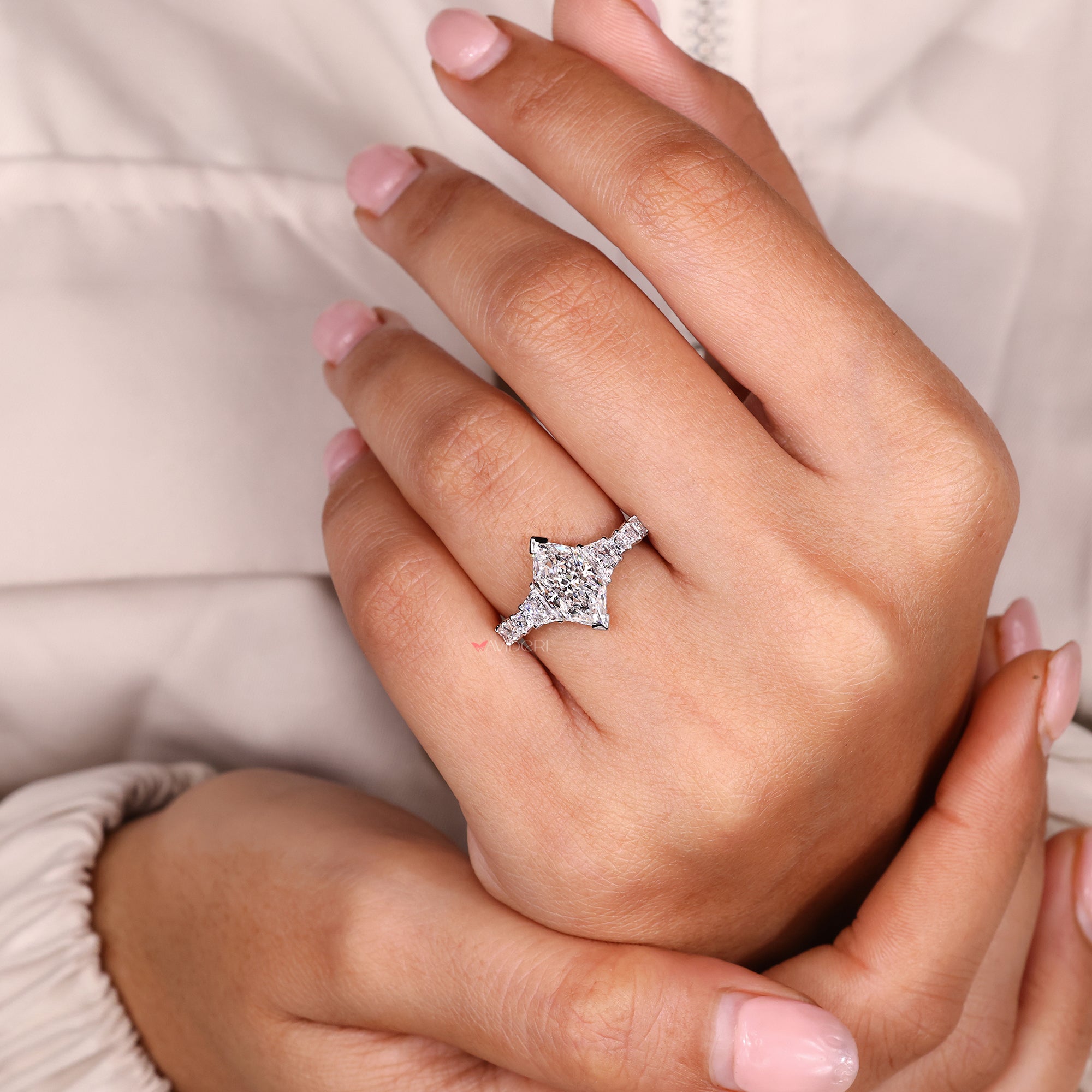 Princess side stone with v prong setting.