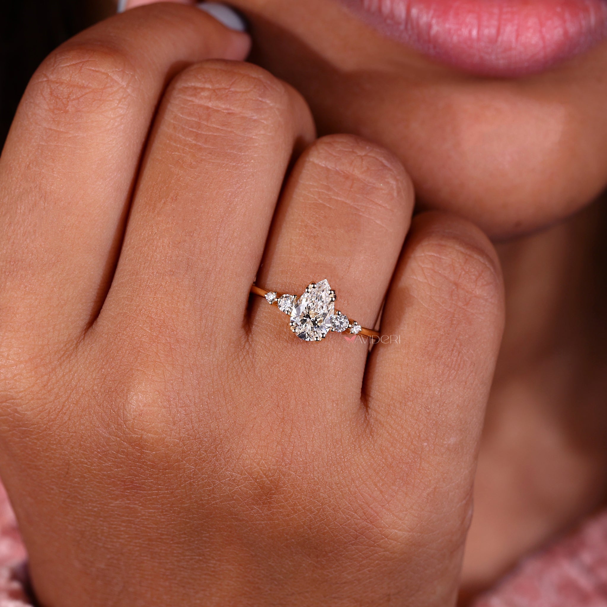 Avideri engagement ring with 5 stone engagement ring style and four round diamonds with side stones for brilliance.
