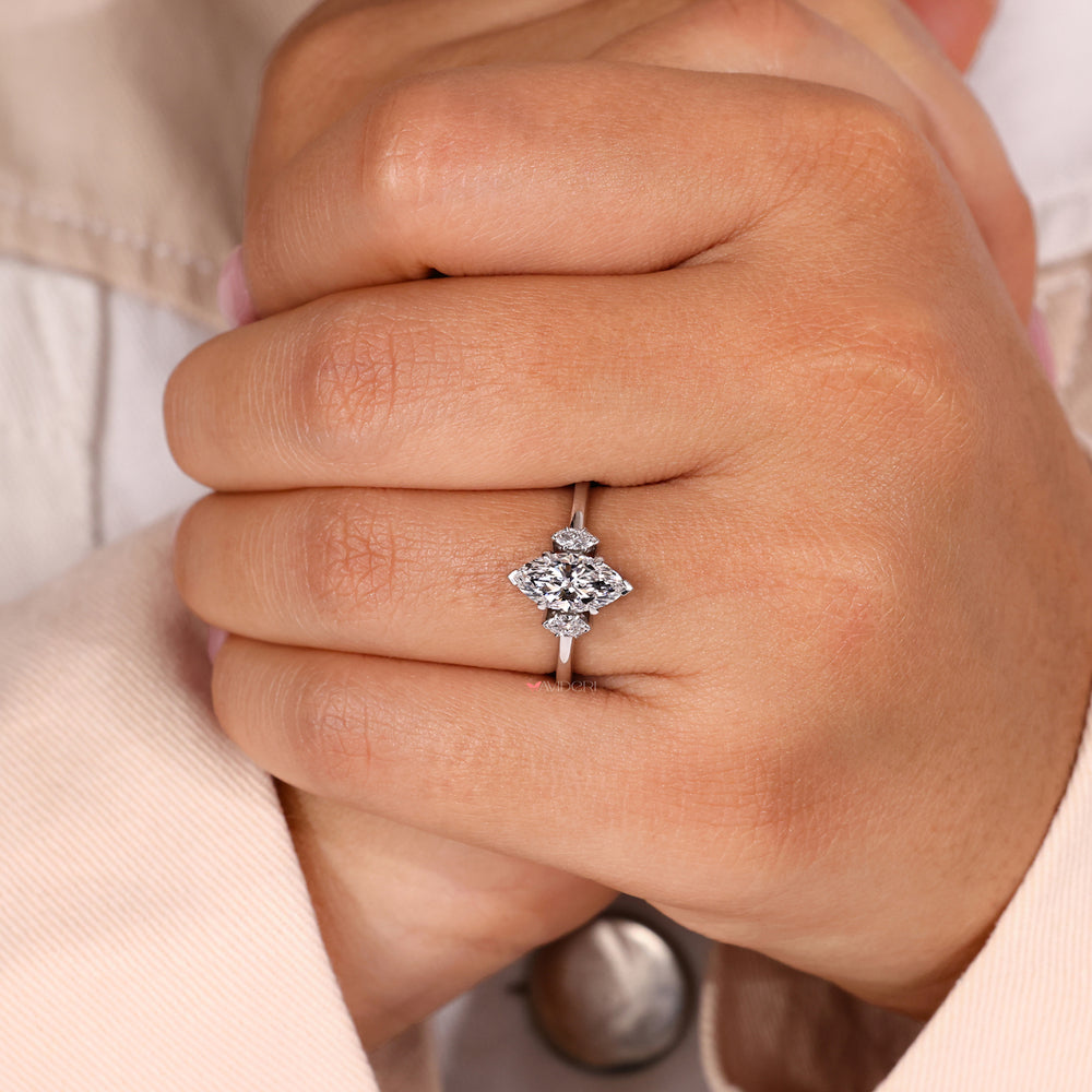 Three diamond ring with a marquise diamond centerpiece, combining timeless appeal and sustainable craftsmanship.
