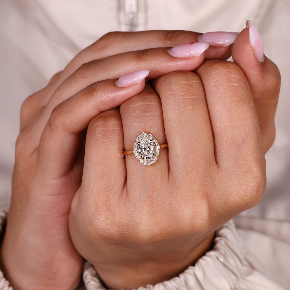 Lab grown oval diamond ring with round halo design.