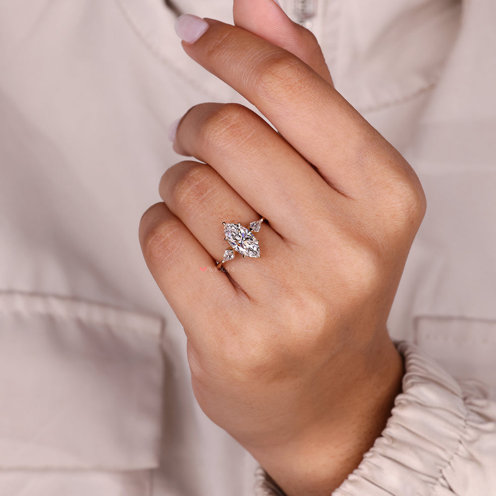 Three stone marquise diamond ring with side details.