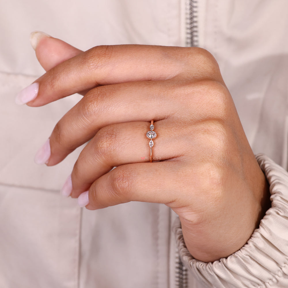Three stone diamond ring with clean bezel design.