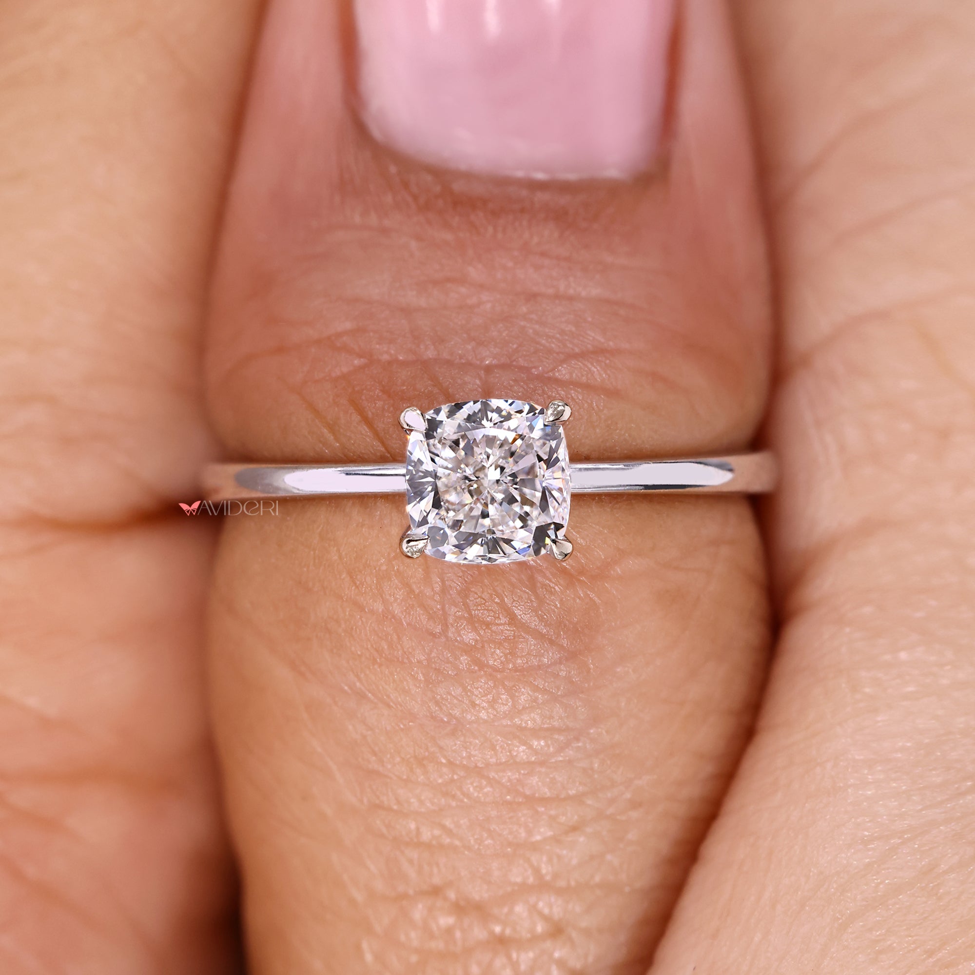 Cushion cut diamond ring featuring four claw prongs.