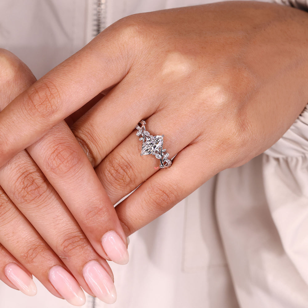 Marquise diamond ring with botanical leaf design.
