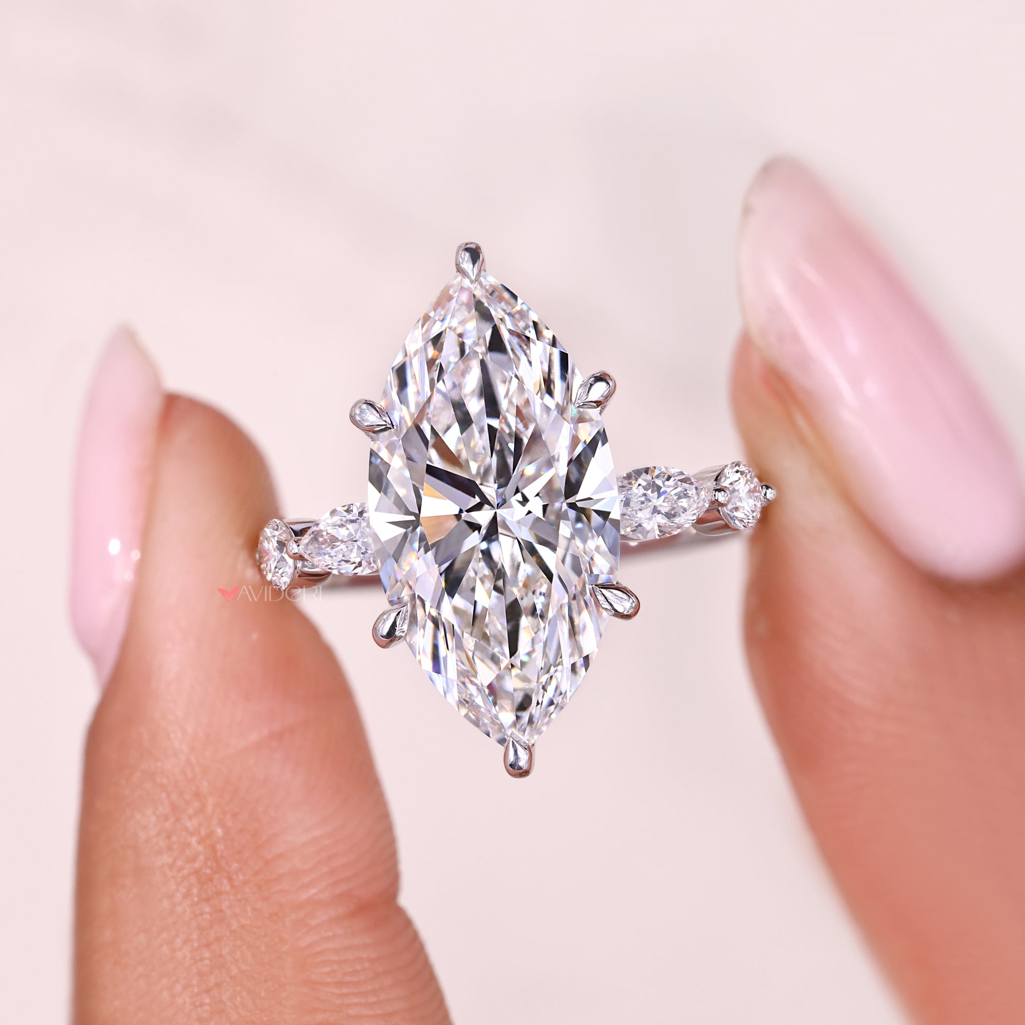 Handmade jewelry marquise side stone engagement ring.