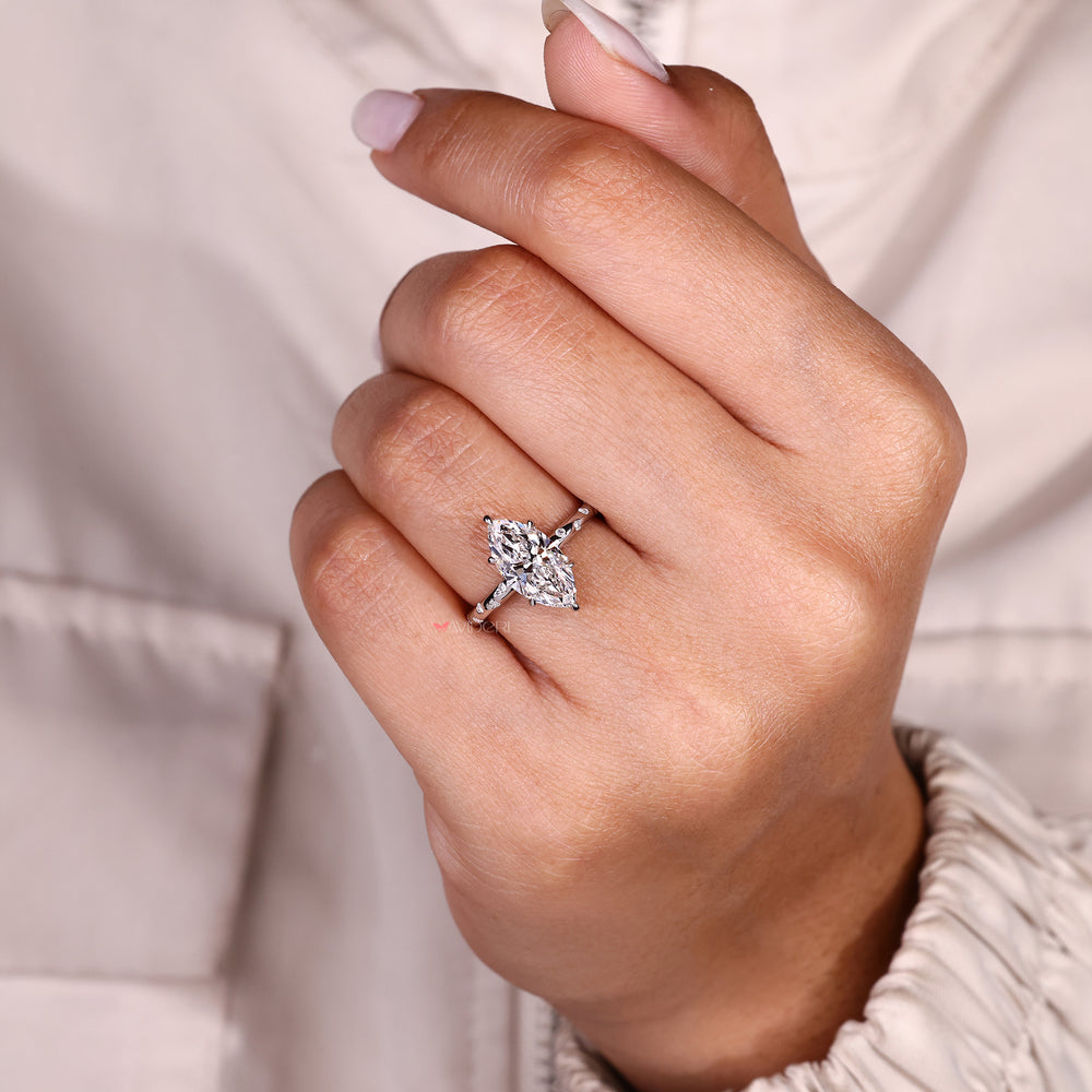 Handmade marquise diamond ring with flush pave setting.
