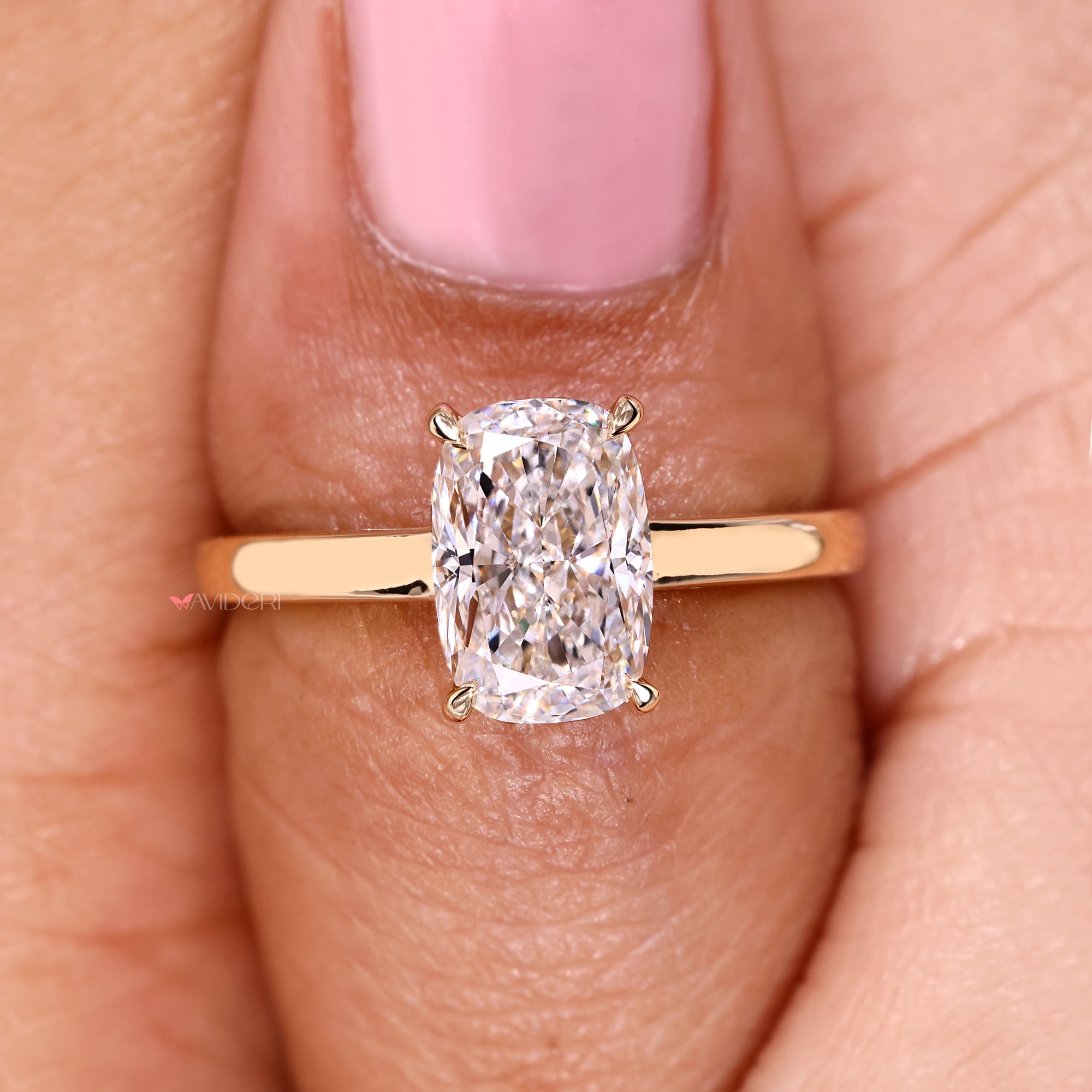 Cushion cut diamond ring with refined solitaire setting.