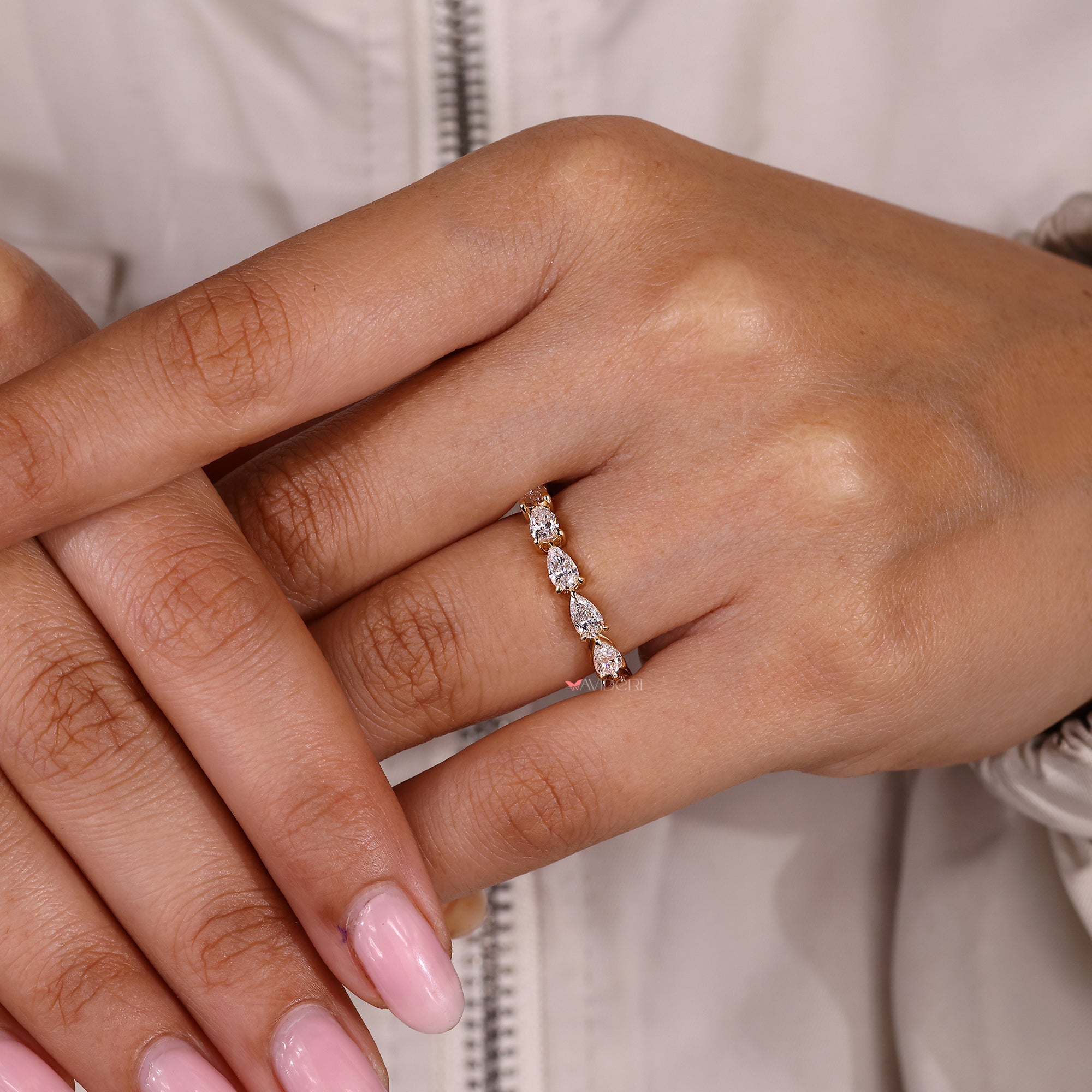 Full eternity band featuring pear cut lab grown diamonds.

