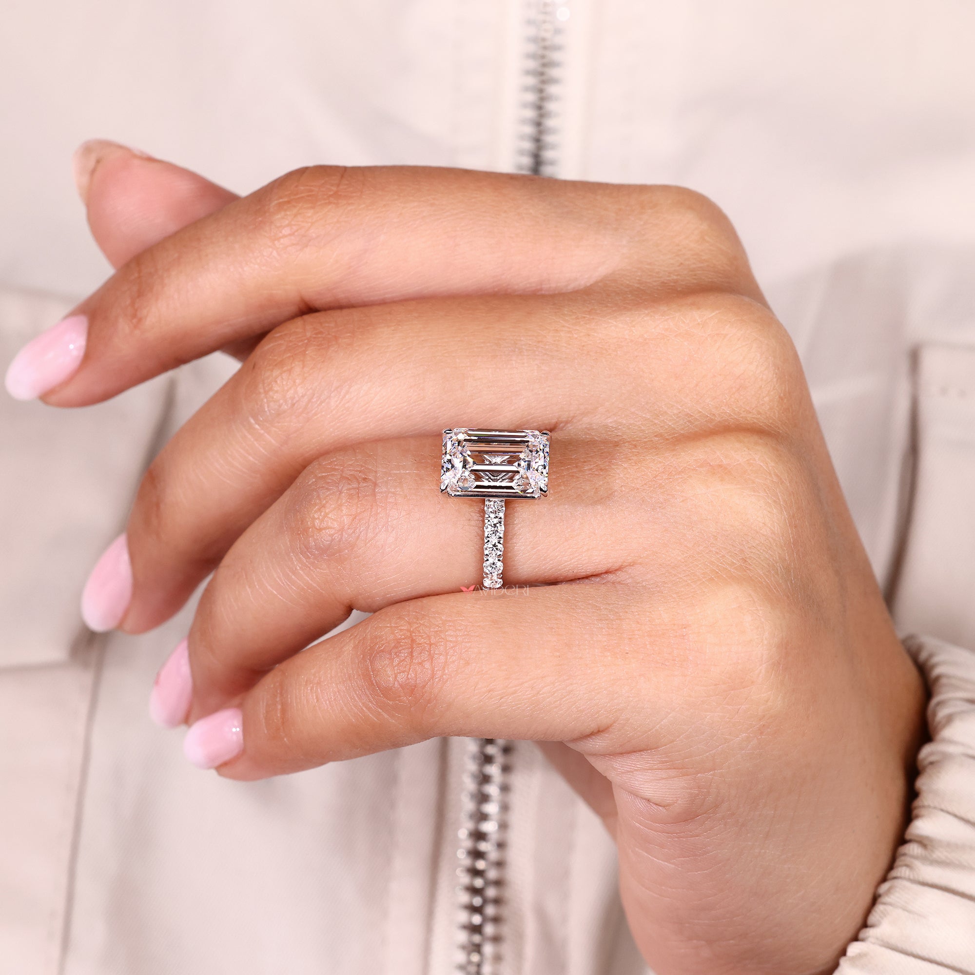 Lab grown emerald cut diamond ring with claw prongs.
