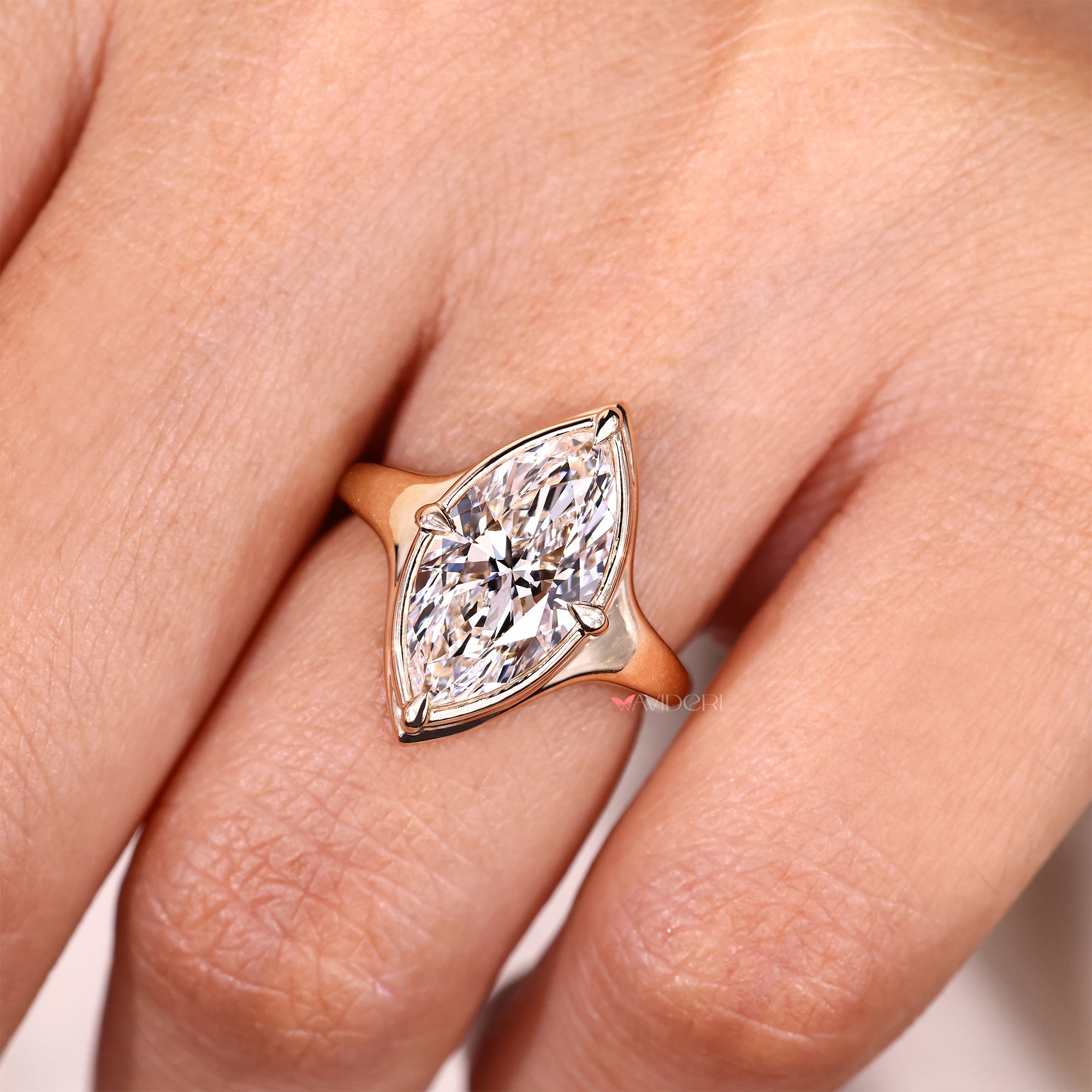Marquise solitaire diamond ring with compass prongs.
