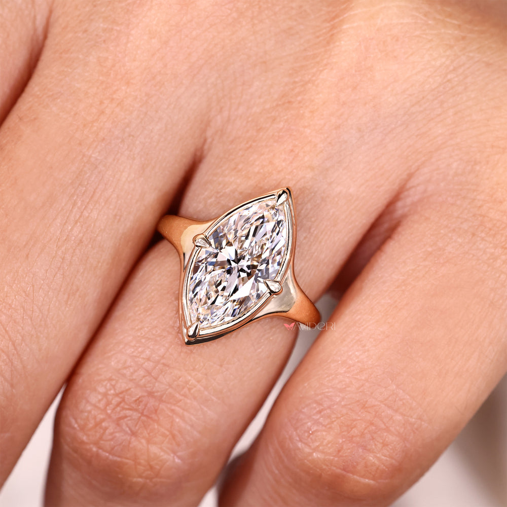 Marquise solitaire diamond ring with compass prongs.