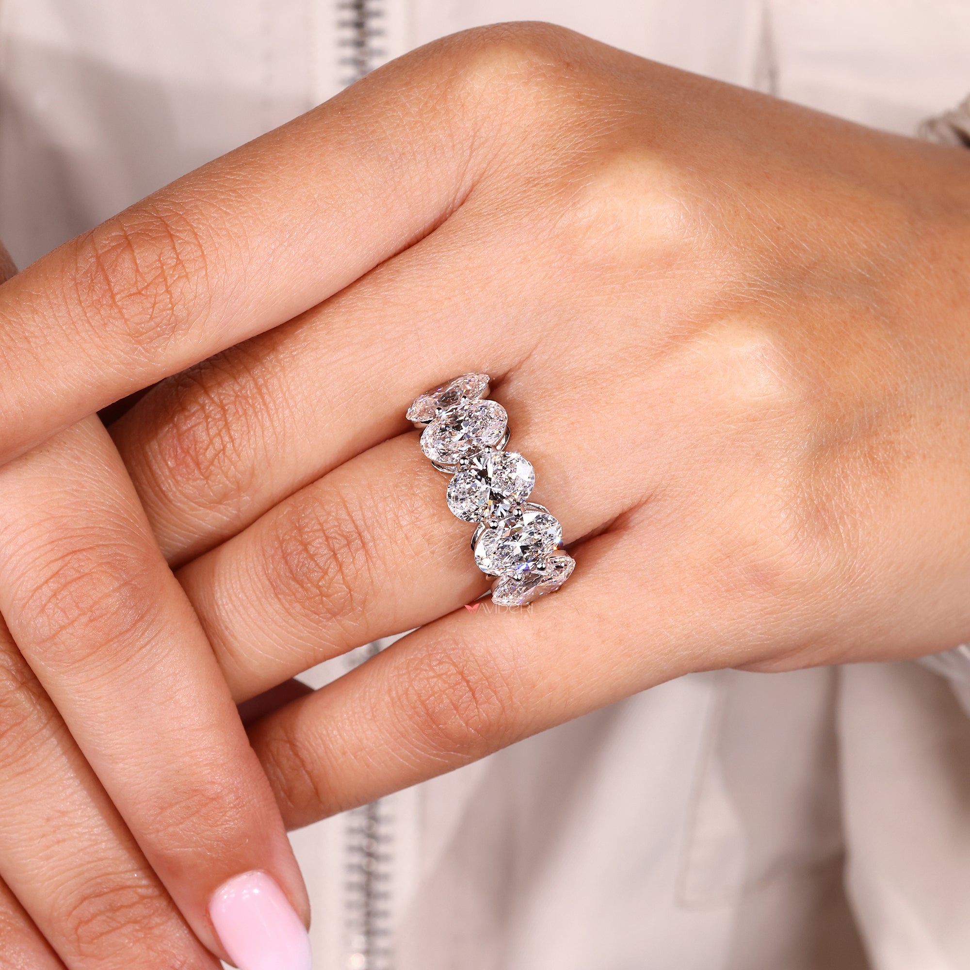 Unique wedding band with oval cut diamonds.