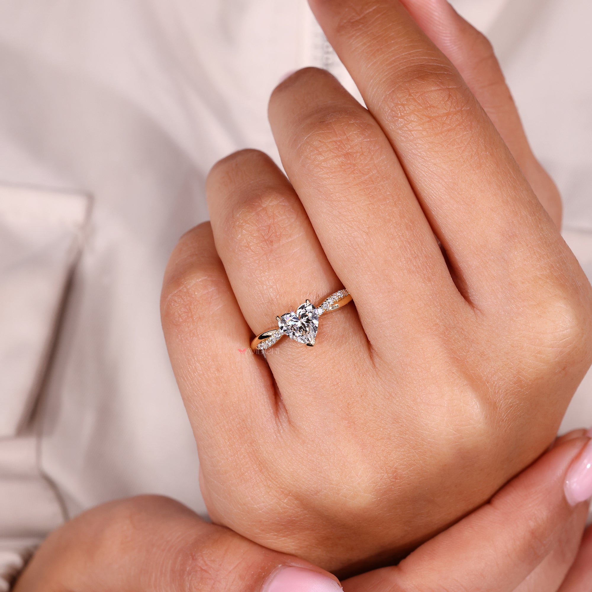 Pave round diamond ring with heart center stone.