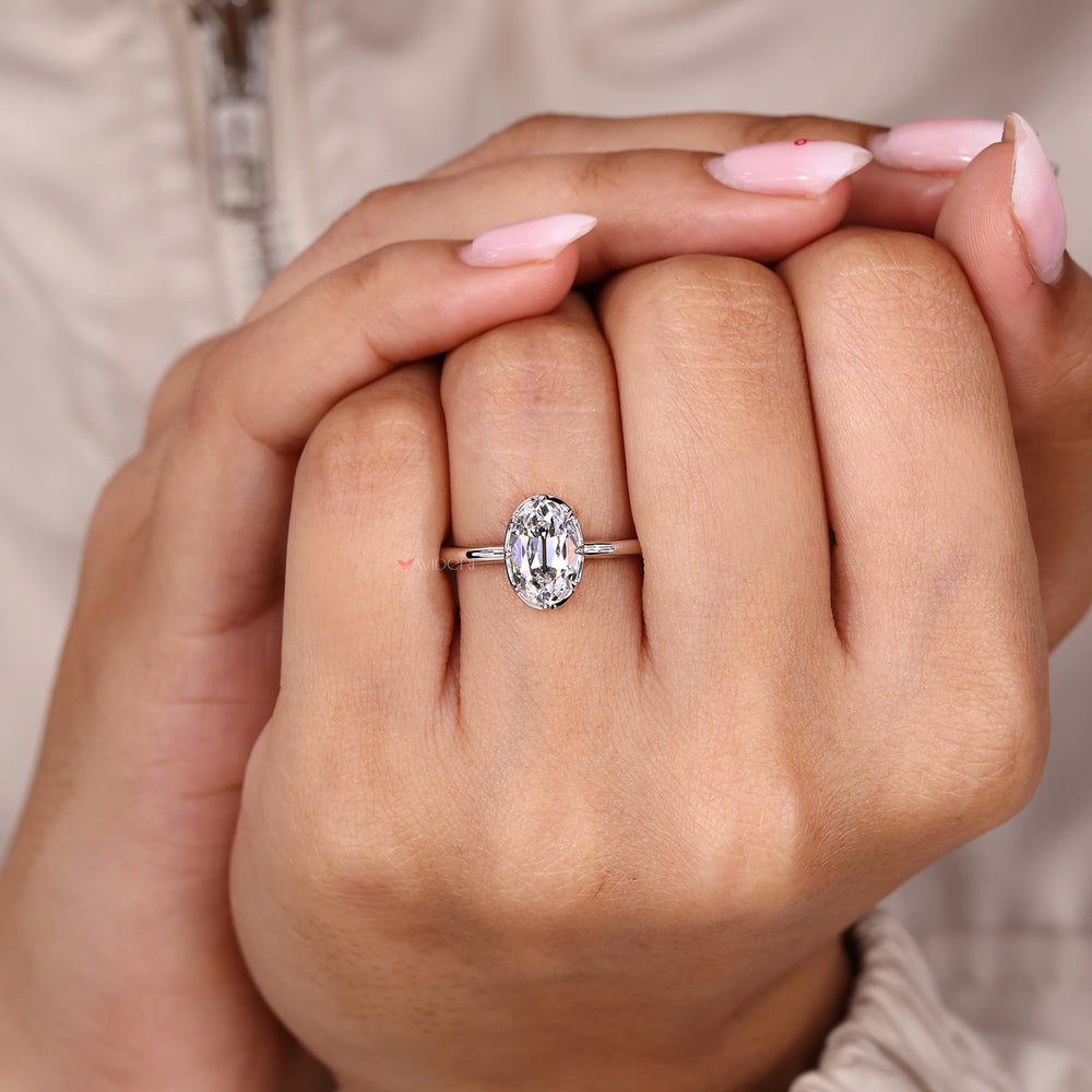 Solitaire diamond ring with oval old European cut bezel.