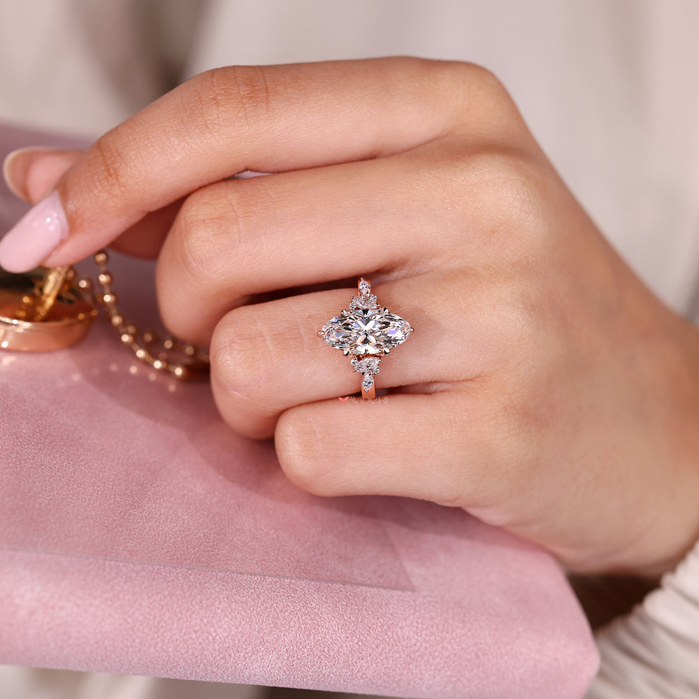 Moval diamond engagement ring with tulip setting.
