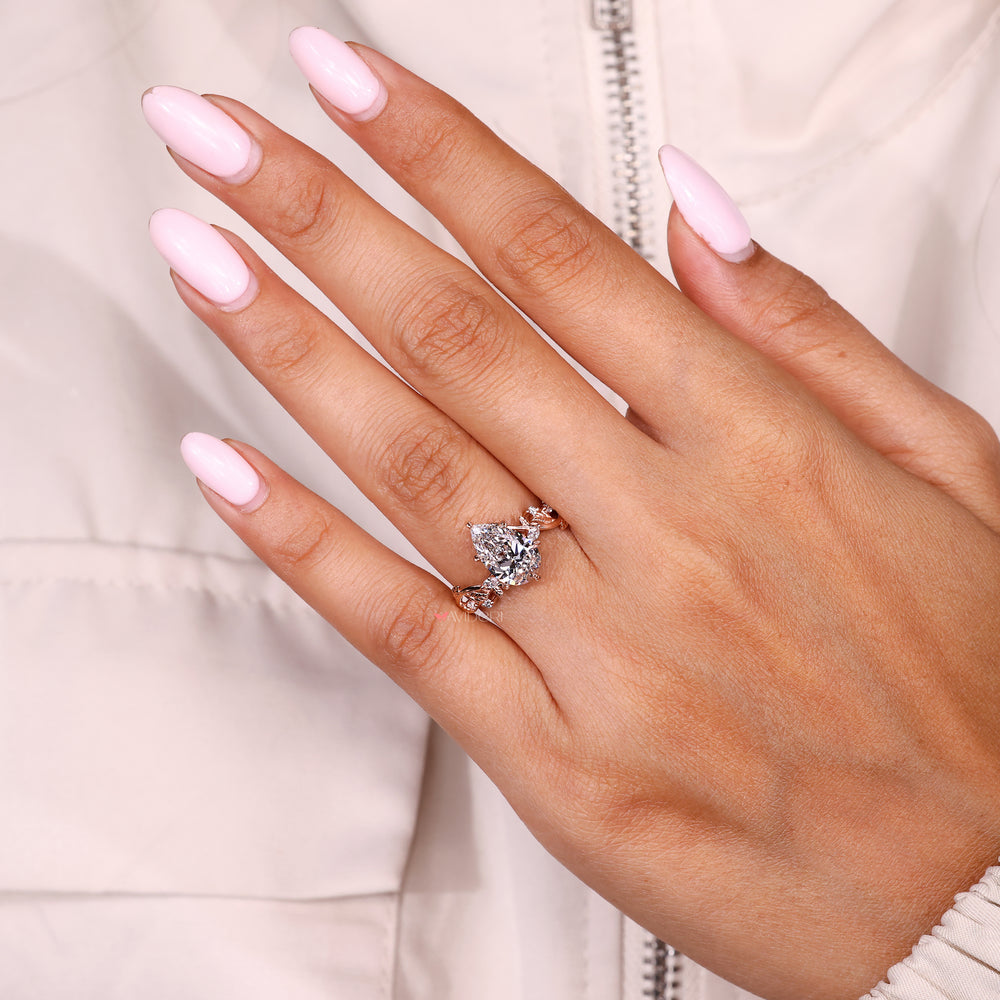 Pear shaped diamond ring with six leaf style setting
