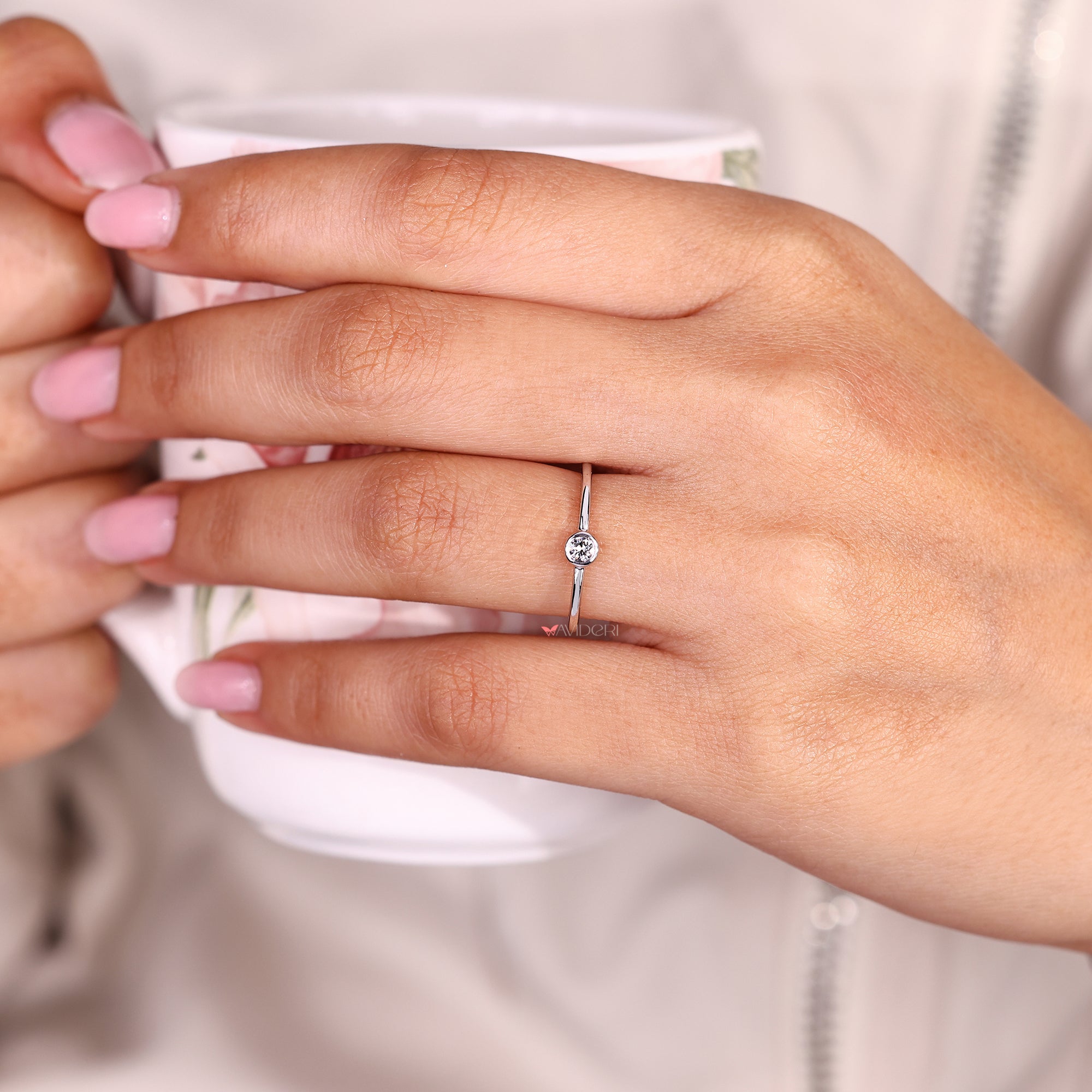 Round diamond bezel ring with minimalist design.
