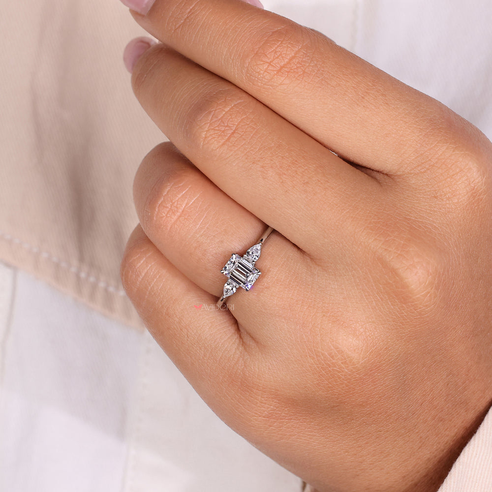 Emerald cut engagement ring paired with engagement rings pear shaped side stones for a sophisticated and unique look.

