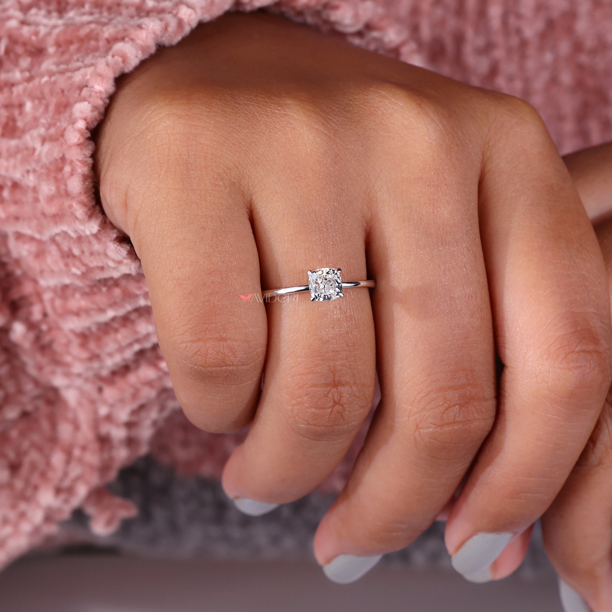 Solitaire engagement ring with a cushion cut solitaire diamond in a classic style.
