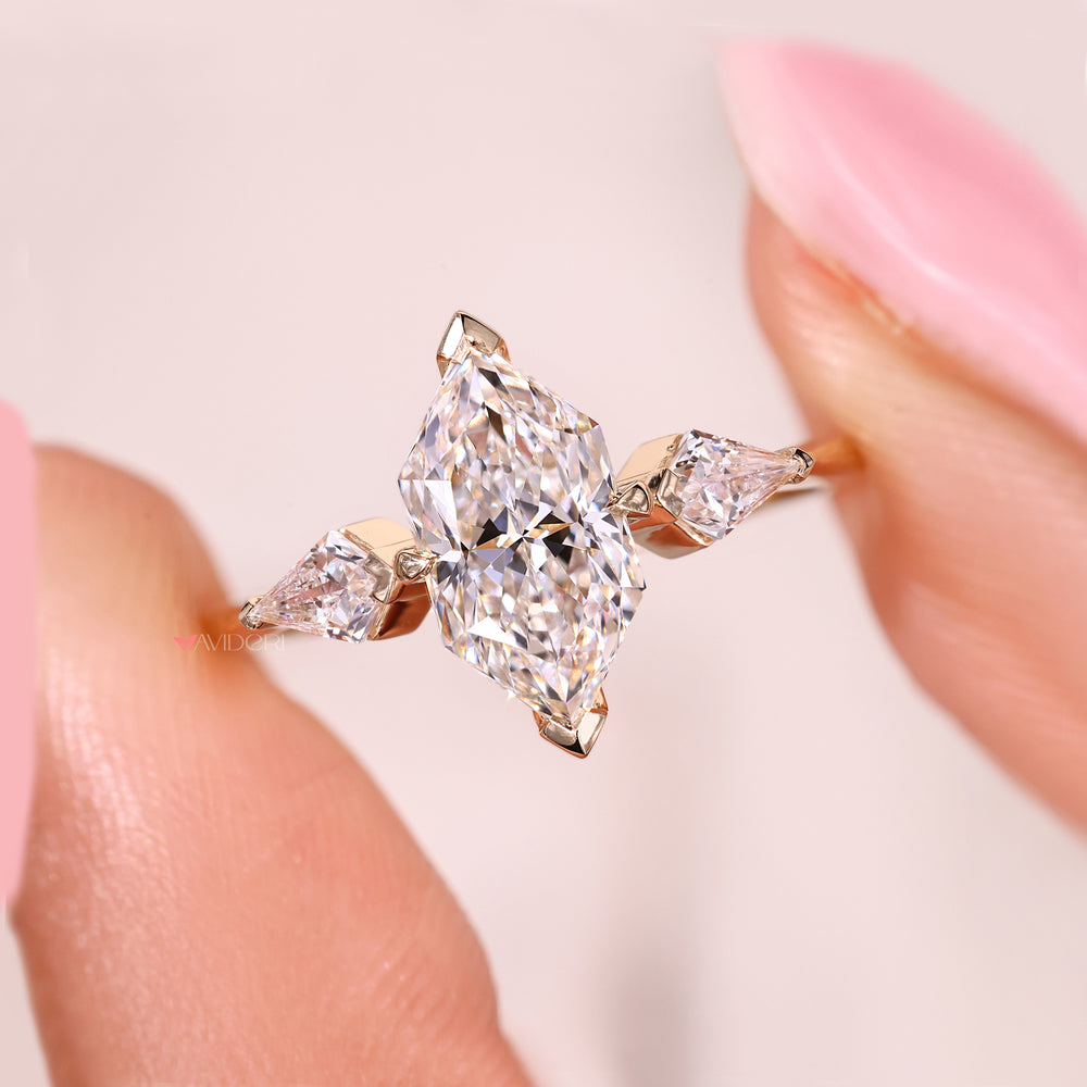 Three stone diamond ring with v prong side stones.
