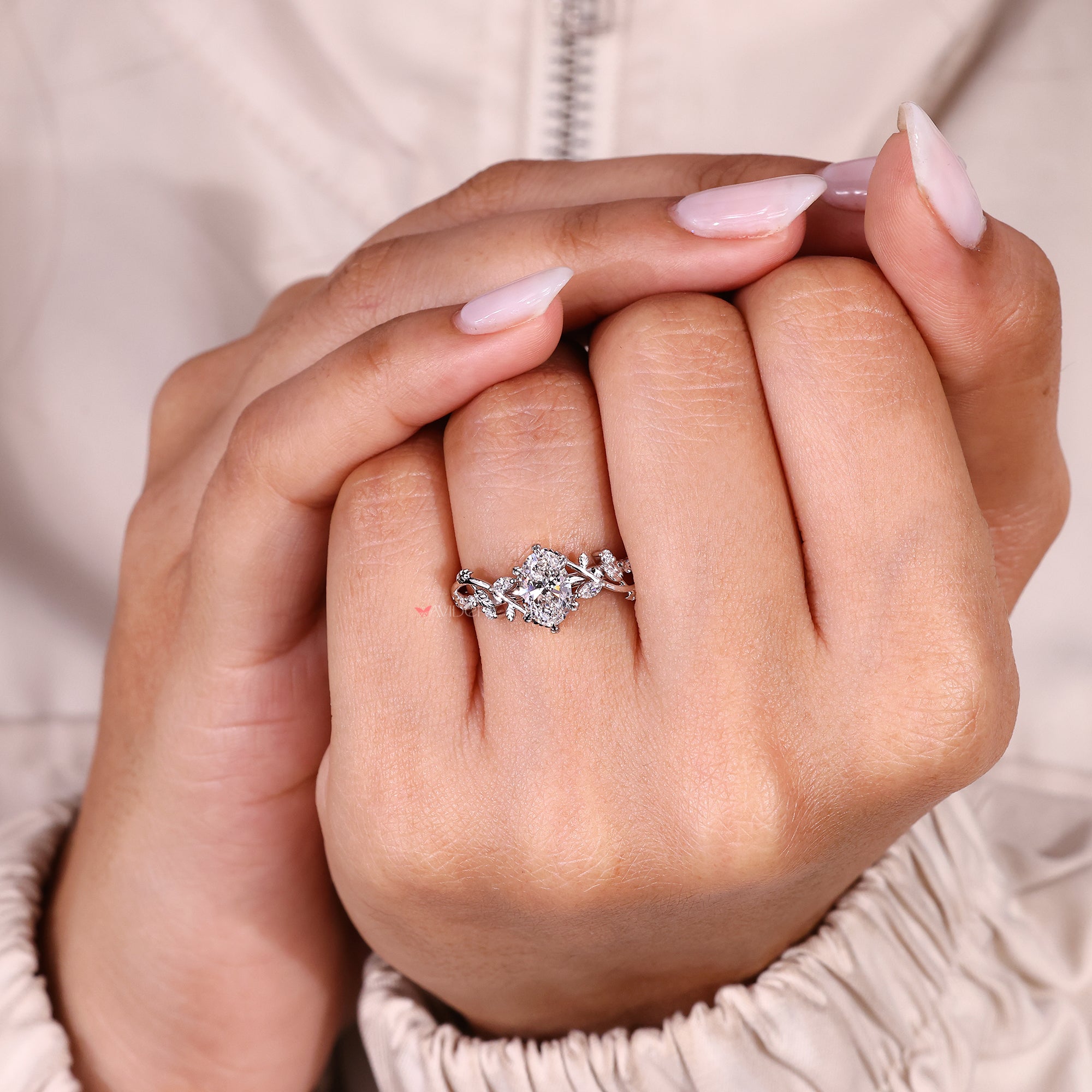 Handmade oval cut diamond ring with round accent stones.
