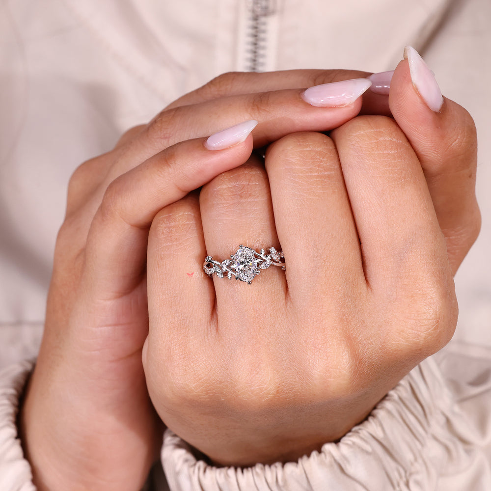 Handmade oval cut diamond ring with round accent stones.
