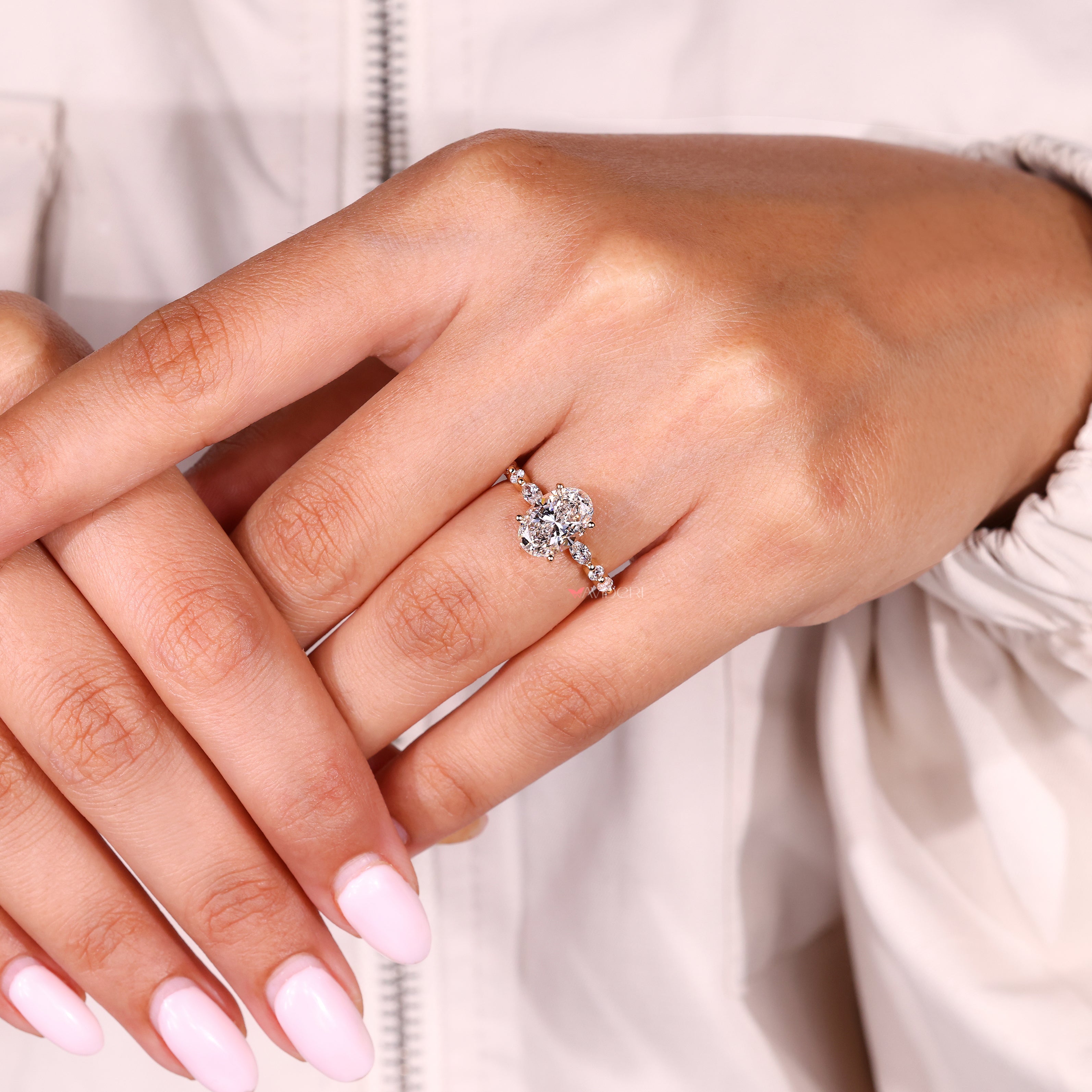 Oval diamond ring with marquise and round side stones

