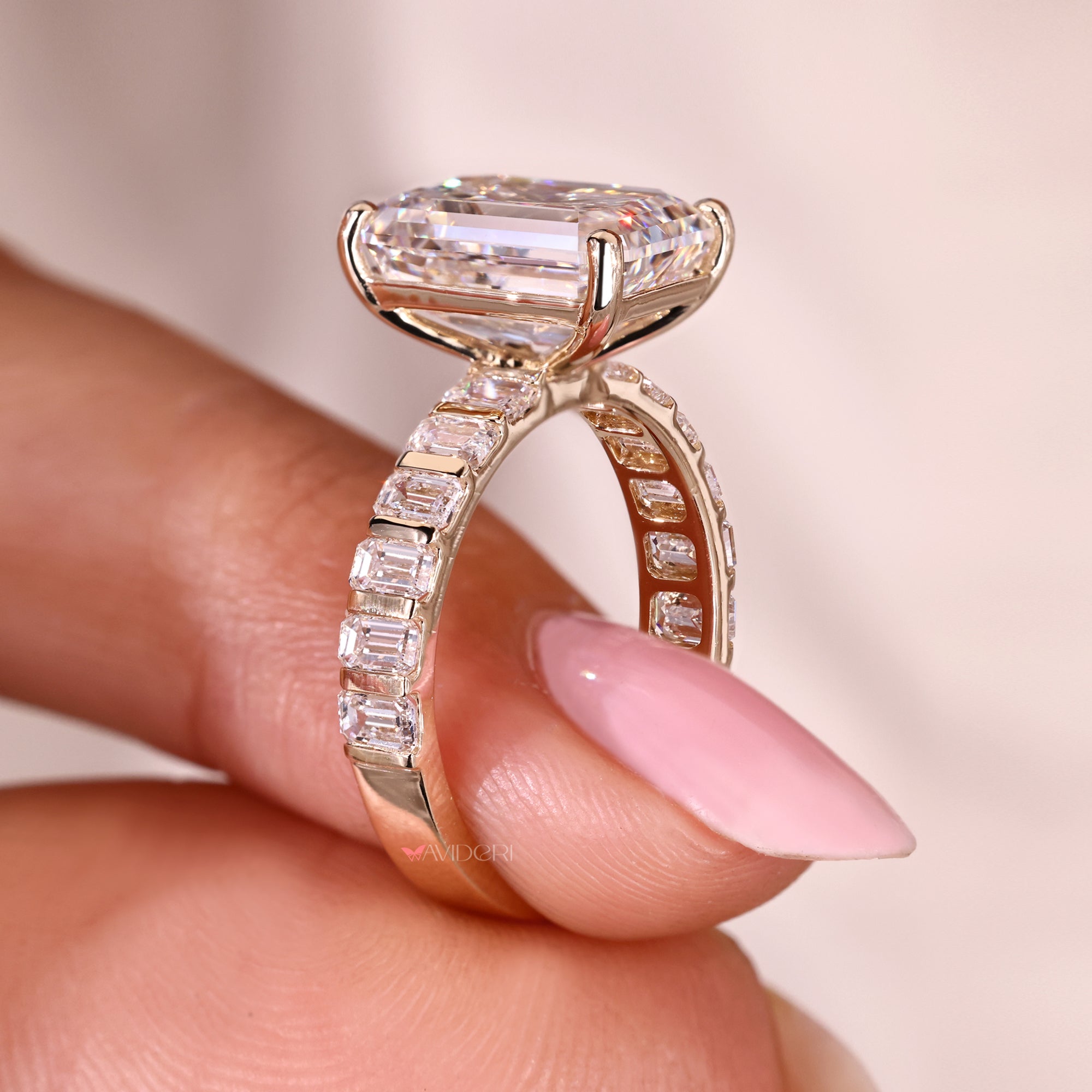 Emerald cut ring with bar set pave band design.
