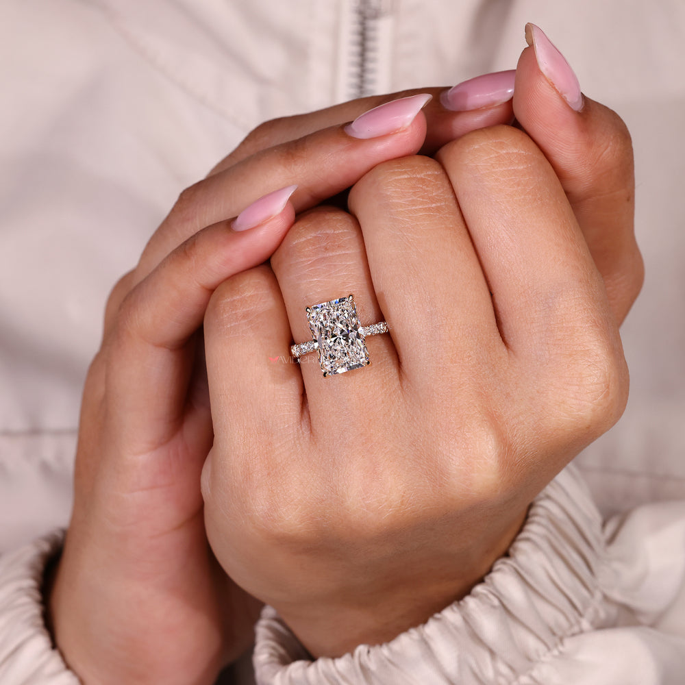 Radiant cut diamond ring with refined tapered shank.
