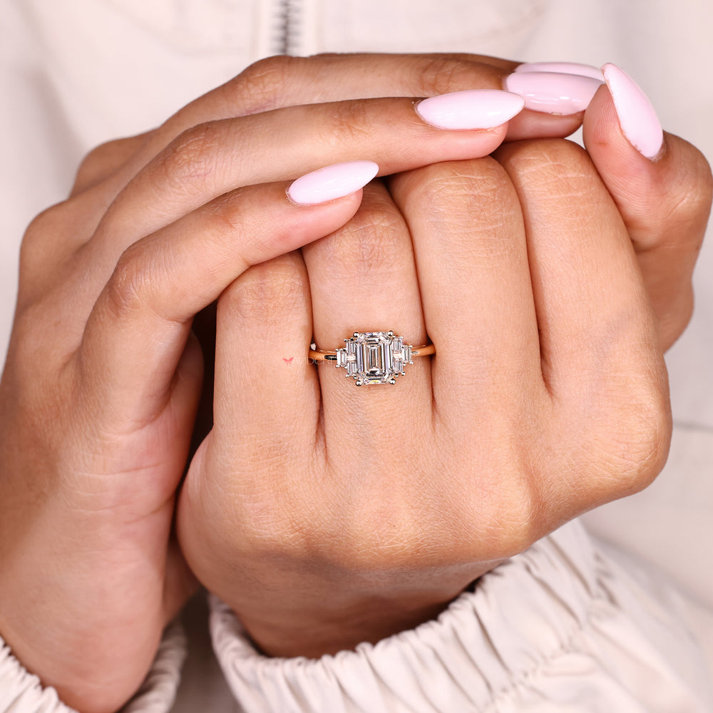 Seven stone emerald diamond ring with baguette side accents
