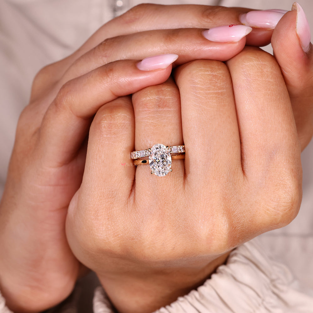Solitaire oval diamond ring with four claw prong setting.