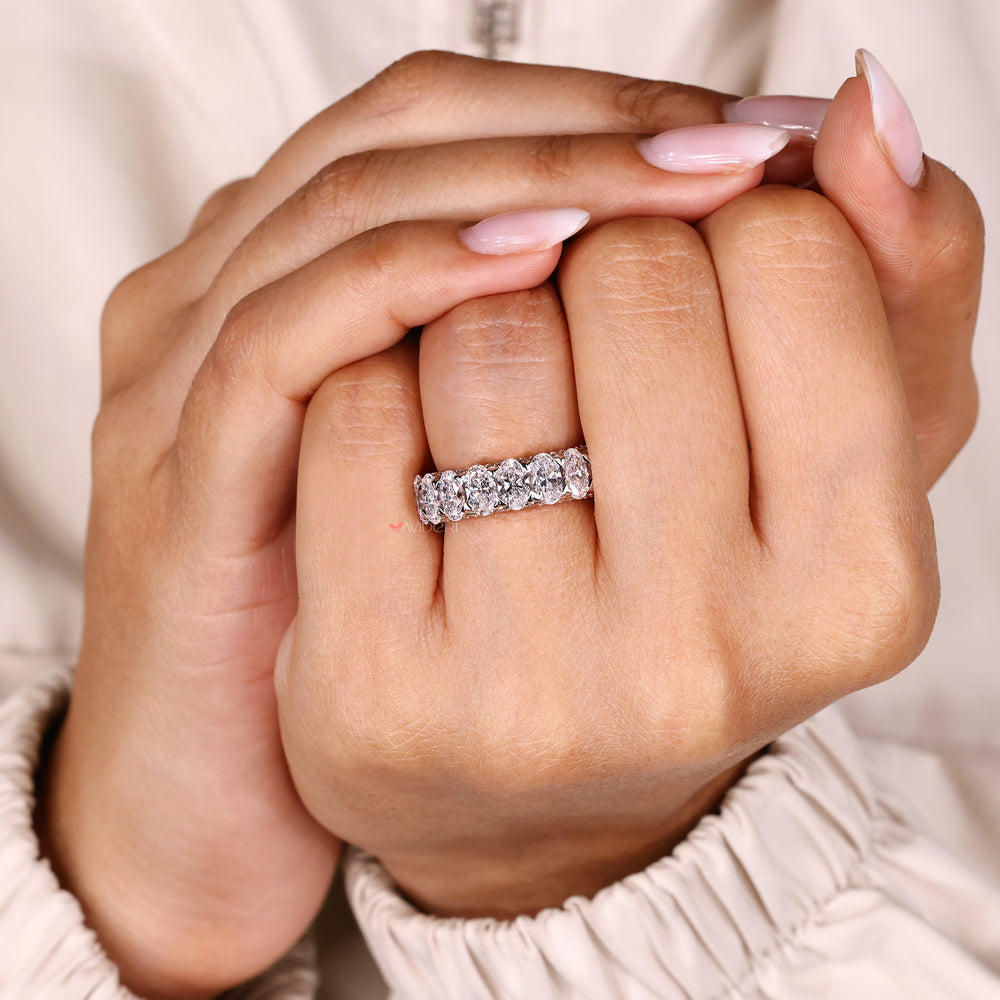 Two tone oval diamond band three row pave.
