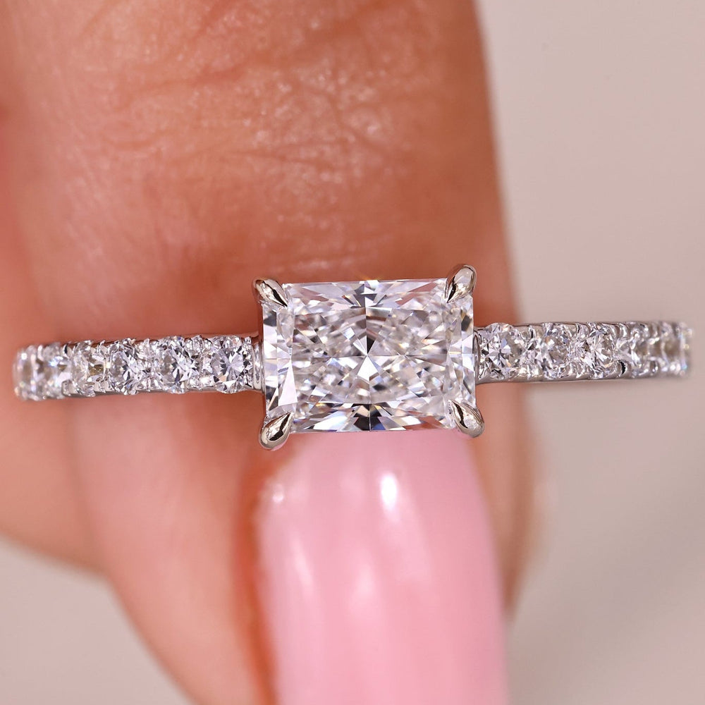 Radiant cut diamond ring with east to west setting.