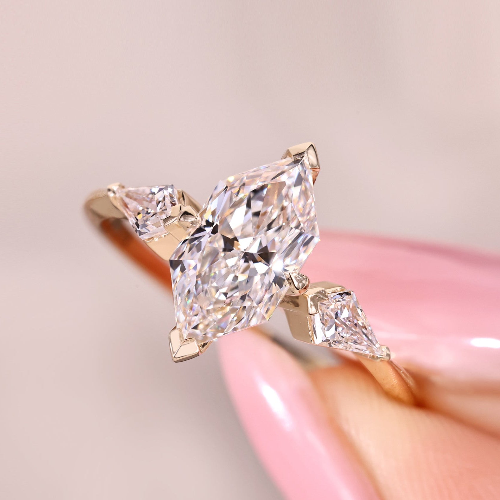 Dutch marquise ring with kite cut side stone accents.

