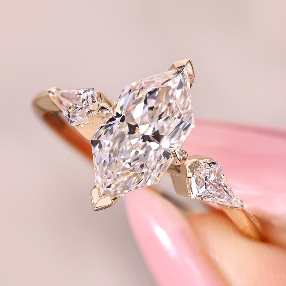Dutch marquise ring with kite cut side stone accents.

