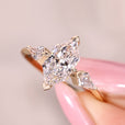 Dutch marquise ring with kite cut side stone accents.
