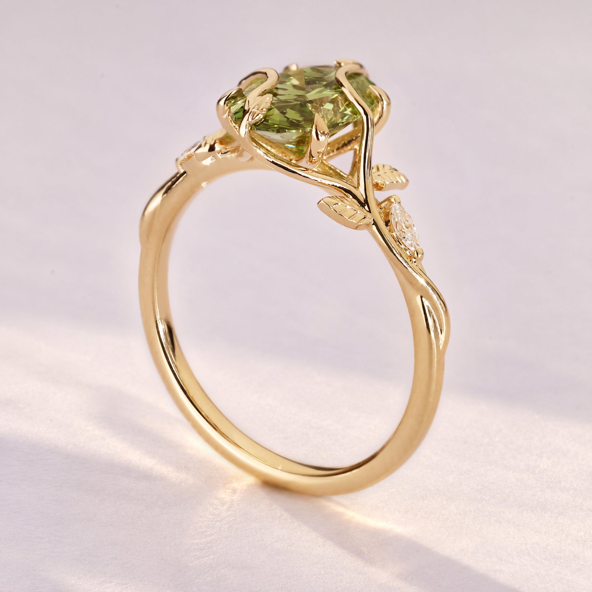 Green oval diamond ring with round side stones.