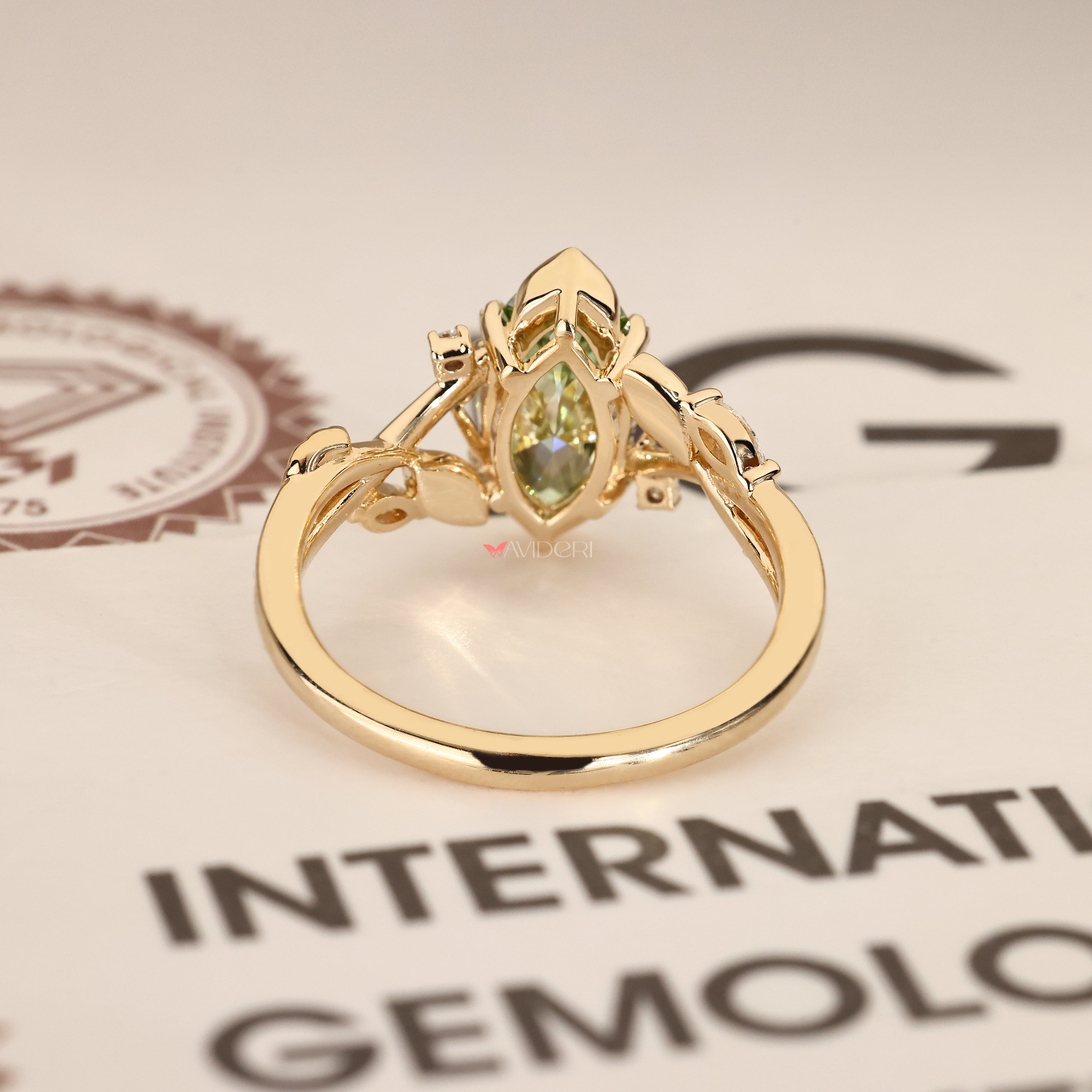 Marquise diamond ring with leaf and vine details.
