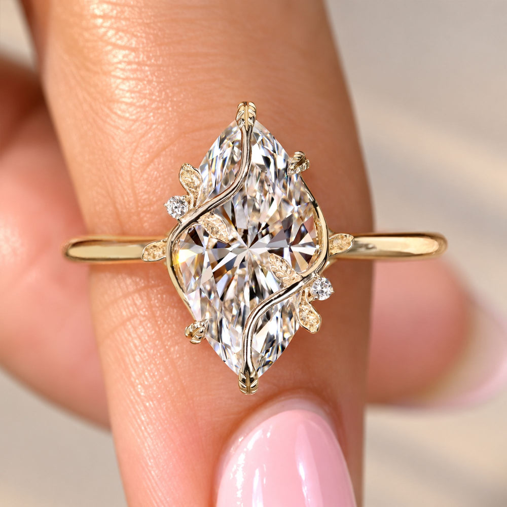 Marquise diamond engagement ring with round side stones.
