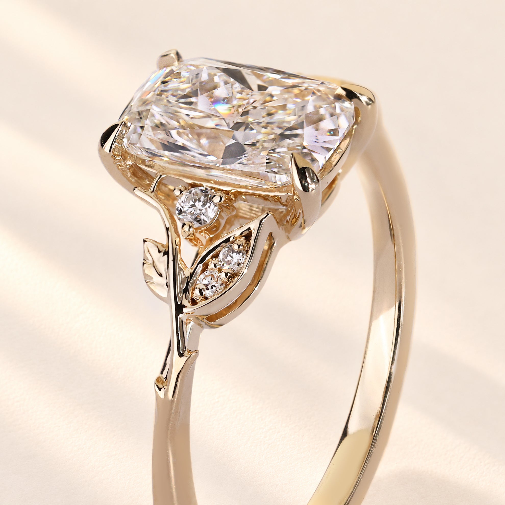 Cushion diamond ring with detailed leaf accents.
