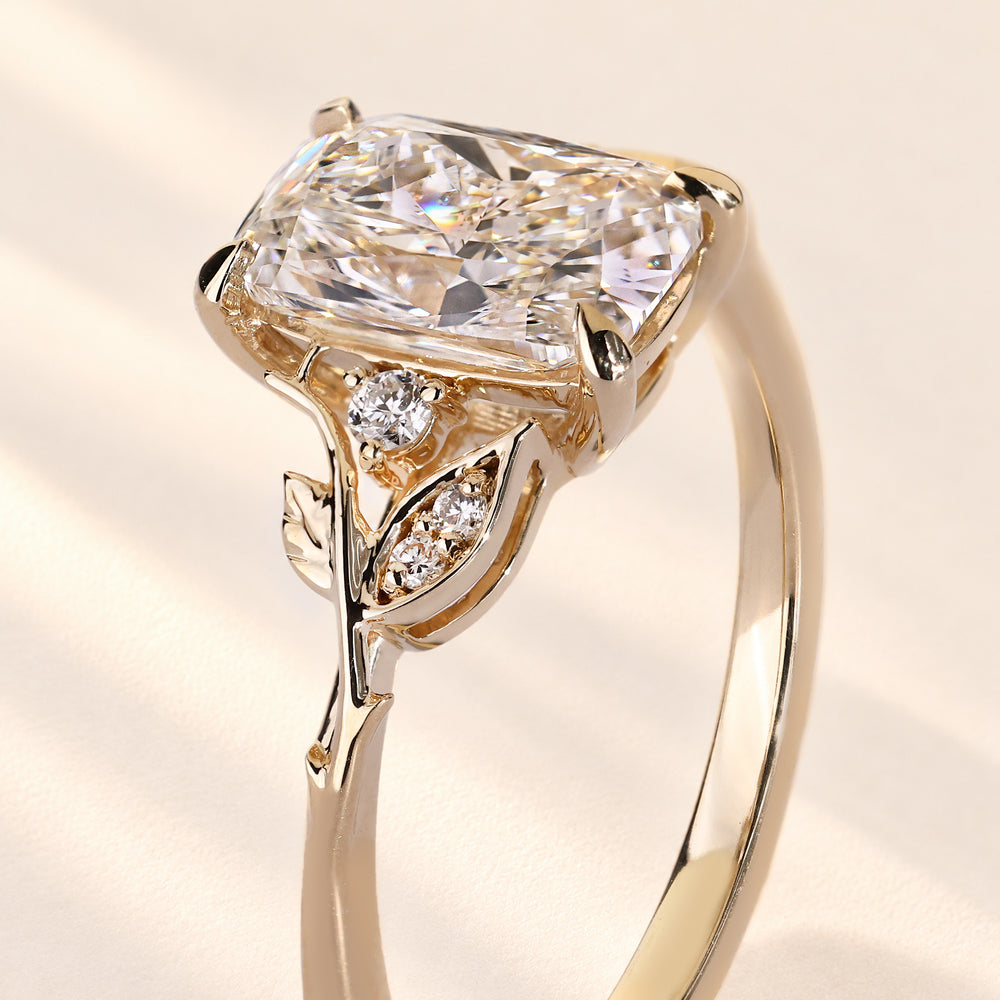 Cushion diamond ring with detailed leaf accents.
