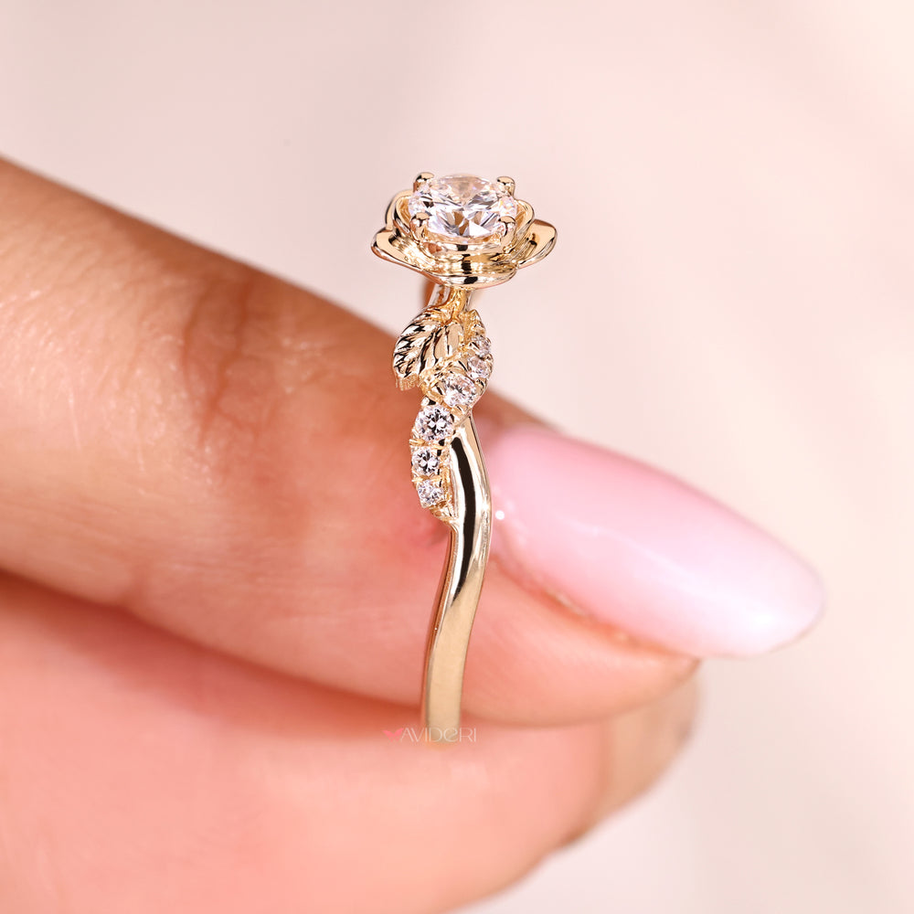 Nature-inspired engagement ring with leaf details and a sparkling round diamond.
