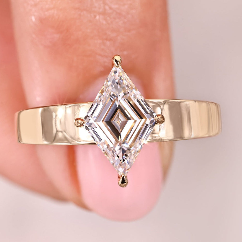 Solitaire engagement ring with lozenge cut diamond ring.