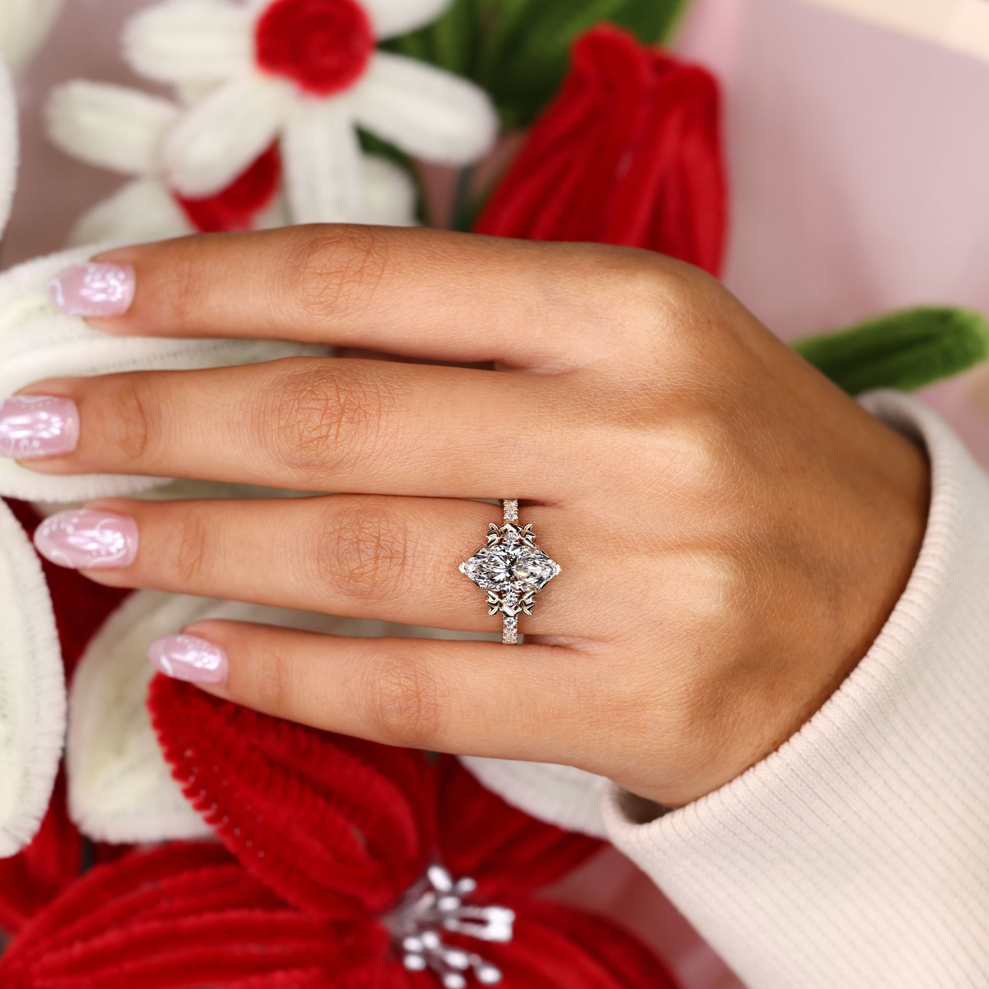 Lab grown marquise diamond ring with leaf prongs.
