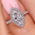 Marquise diamond engagement ring with compass prong setting.