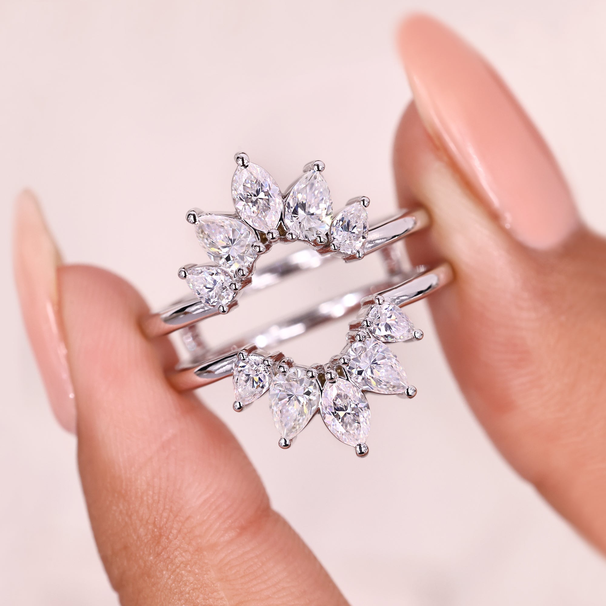 Curved wrap guard band with marquise pear moissanite.
