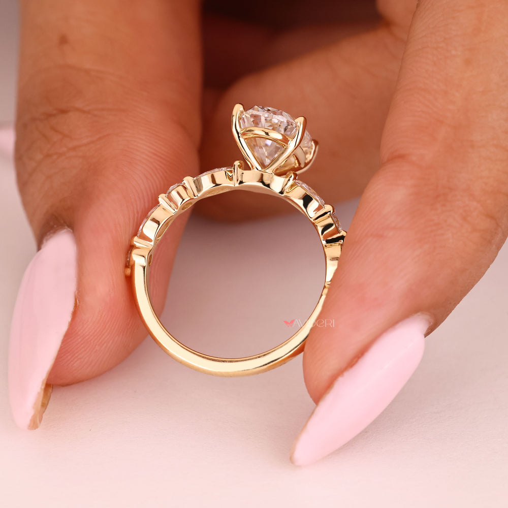 Four prong oval diamond ring with pave style band
