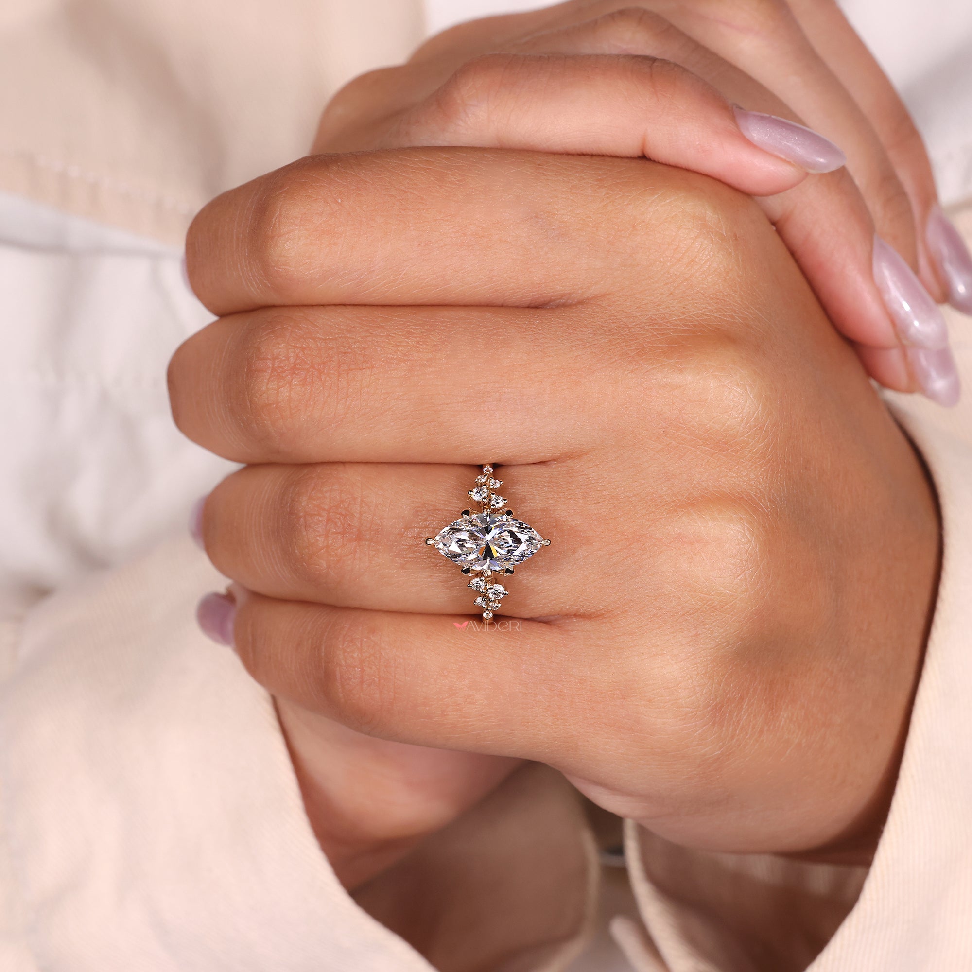 Buy engagement ring with marquise and round diamonds, set in a secure and stylish band.
