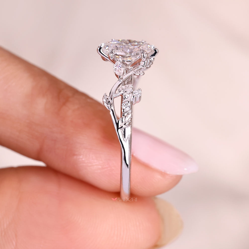 Nature inspired oval diamond ring with six leaf style prong setting.
