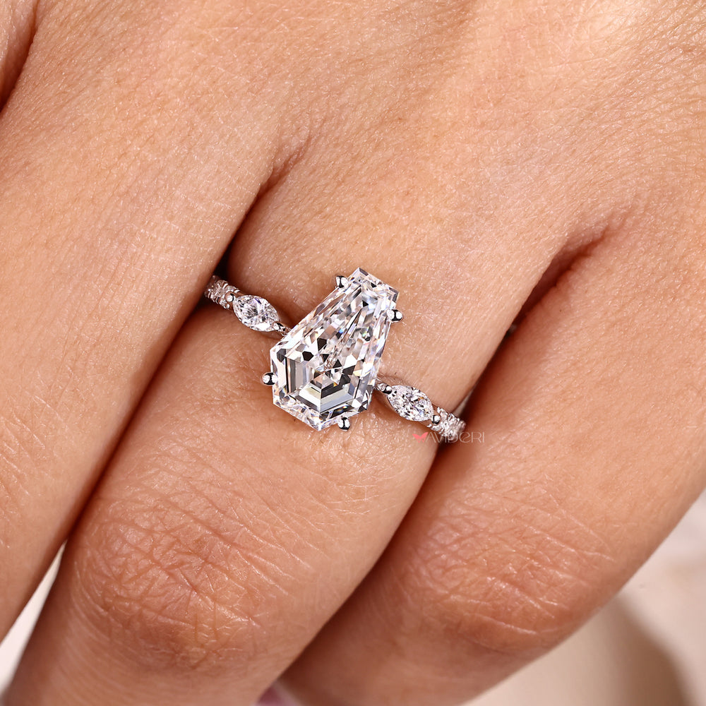 Four prong coffin cut diamond ring with pave band.